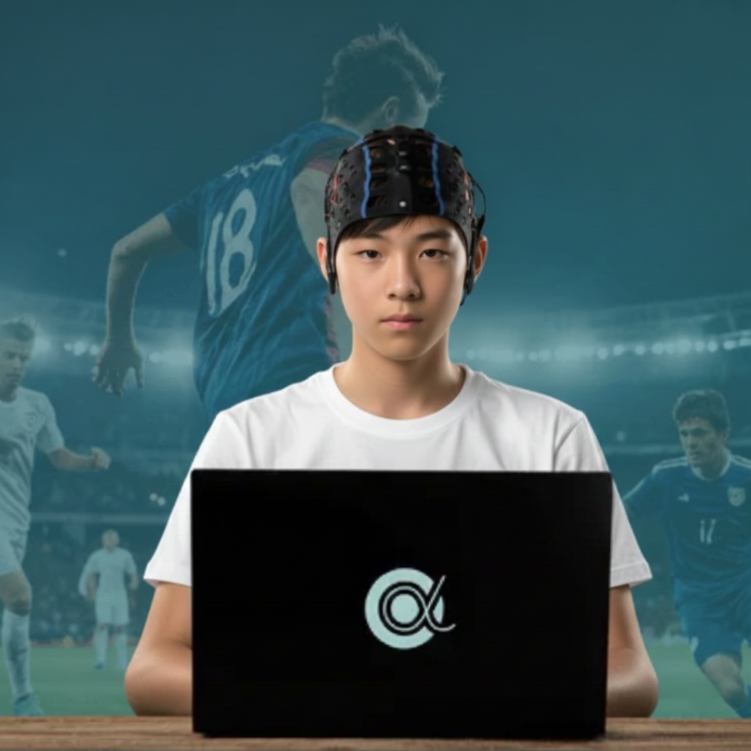 A boy sits in front of a computer where he is doing i-Brain training.